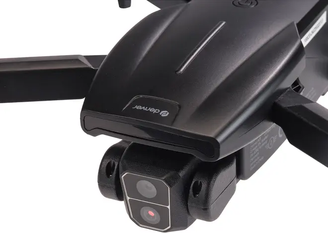 Nærbillede af sort drone med frontvendt kamera med to linser, foldbare arme og aerodynamisk design. Velegnet til luftfotografering og videooptagelse.