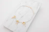 Halsband med pärlor och rosetter - guld