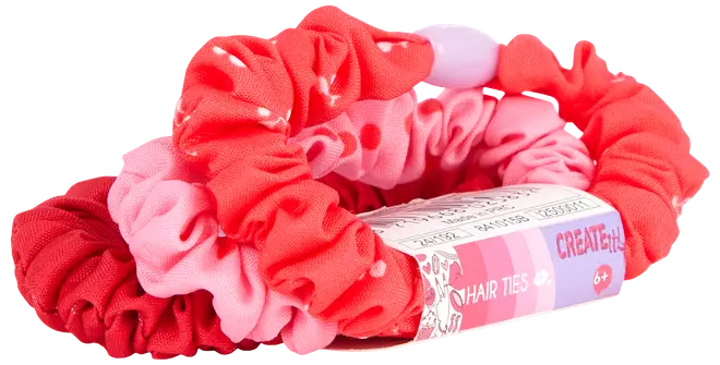 Sæt med tre stof-scrunchies i røde og lyserøde nuancer med prikker, designet til børn fra 6 år. Leveres med mærket papiretikette.