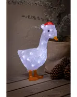 Upplyst gås juldekoration med vita LED-lampor, orange näbb och fötter samt röd tomteluva. Tillverkad av texturerat material, för inomhusbruk.