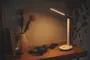 Moderne hvid LED-skrivebordslampe med slankt, justerbart arm og touch-kontrol på basen. Giver varmt lys, minimalistisk design, kompakt størrelse, ideel til skriveborde.