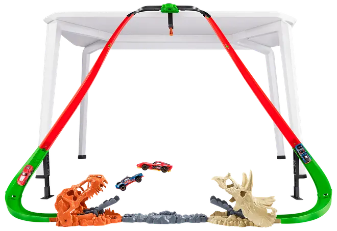 Hot Wheels banesæt med to røde buede baner, dinosaur-tema affyringsramper og to legetøjsbiler. Monteres på et bord for hævet racerløb og stunts.