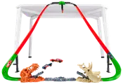Hot Wheels banesæt med to røde buede baner, dinosaur-tema affyringsramper og to legetøjsbiler. Monteres på et bord for hævet racerløb og stunts.