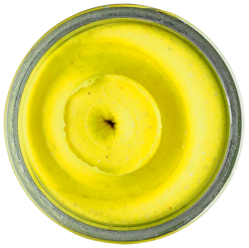 Toppvy av en glasburk fylld med ljusgul, krämig body butter eller lotion, slät vispad konsistens och lätt virvelmönster på ytan.