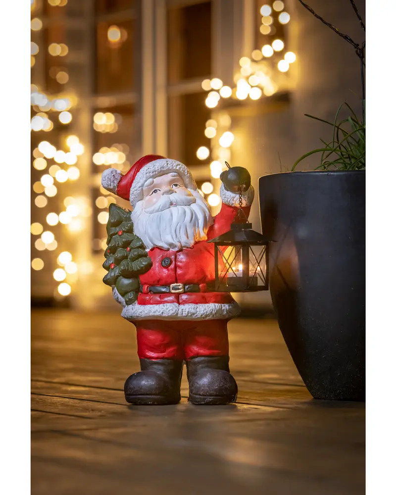 Jultomte med gran och lanterna