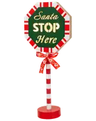 Festlig skylt med röda och vita ränder, grön åttakantig framsida, gul "Santa STOP Here"-text, röd bas och rött band. Perfekt för juldekoration.