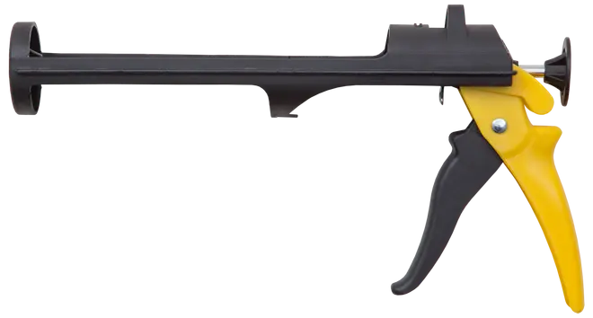 Robust fogpistol med svart cylinder och gult handtag, avsedd för applicering av fogmassa eller lim. Ergonomiskt grepp och avtryckare för enkel, kontrollerad användning.