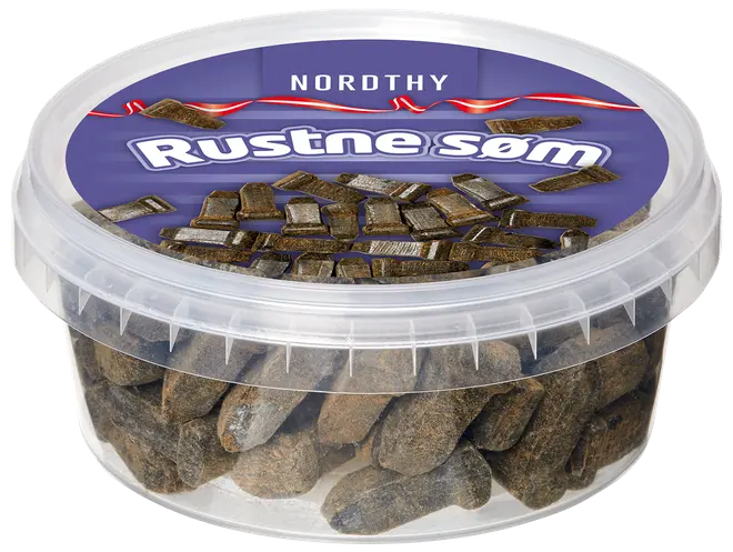 Plastbøtte med Nordthy Rustne Søm, dansk slik formet som rustne søm, dækket af brunligt pulver, med genlukkelåg og lilla etiket.