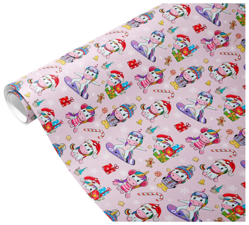 The image shows a roll of wrapping paper with a festive design featuring cartoon unicorns in various winter and holiday outfits. The unicorns are depicted wearing Santa hats, scarves, earmuffs, and winter coats, some holding presents or riding snowboards. The background is light pink and decorated with small illustrations of candy canes, gingerbread men, snowflakes, stars, and wrapped gifts, creating a cheerful and playful holiday theme.