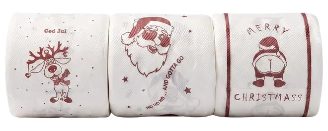 Tre hvide toiletpapirruller med røde juletryk: et rensdyr, Santa-ansigt og et “Merry Christmass” kanindesign.