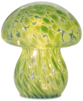 Svampeformet glaslampe med grønne og gule pletter. Lampen udsender et blødt lys, perfekt til dekoration eller stemningsbelysning. Glat, blank overflade med afrundede kanter.