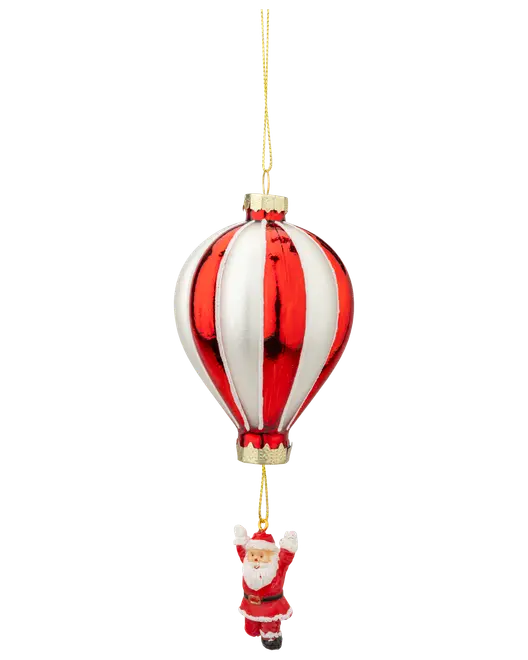 Julepynt i glas formet som en rød og hvid luftballon med en lille julemand hængende nedenunder, fastgjort med en guldsnor til ophængning.