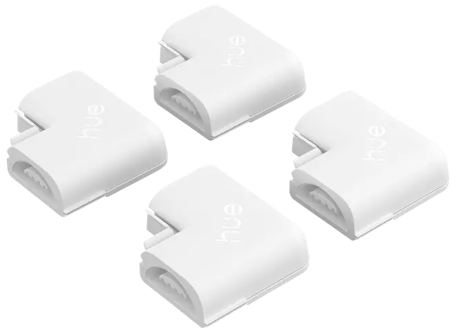 Sæt med fire hvide L-formede stik til Philips Hue lysstrips. Snap-on design for nem montering i hjørner. Hvert stik er kompakt og mærket med 'hue' logoet.