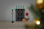Miniature juledør med stribet markise, krans, sort lygtepæl, rød postkasse, træsko, skilt og små tilbehør. Perfekt til juledekoration eller nissedør.