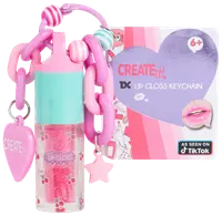Læbepomade-nøglering med pink og turkis låg, kirsebærmotiv, kraftig pink kæde, hjerte- og stjernevedhæng. Inkluderer emballage til 6+, mærket "Create It!"