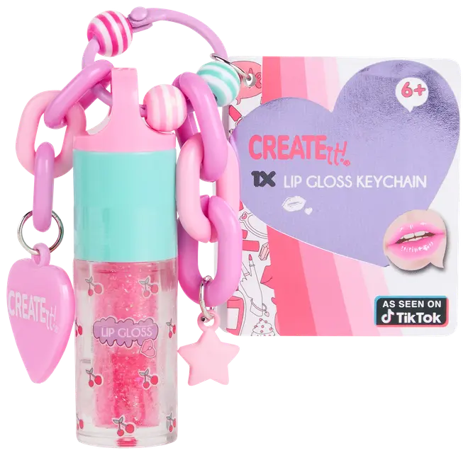 Læbepomade-nøglering med pink og turkis låg, kirsebærmotiv, kraftig pink kæde, hjerte- og stjernevedhæng. Inkluderer emballage til 6+, mærket "Create It!"