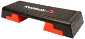 Reebok aerobic stepbænk med skridsikker sort overflade, røde justerbare fødder og hvidt logo. Velegnet til steptræning, kondition og styrketræning. Holdbar og let.