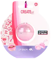 Kugleformet lyserød læbepomade i klar plastbeholder, pakket på farverigt kort med dekorationer. Velegnet til børn fra 6 år. Markedsført som set på TikTok.