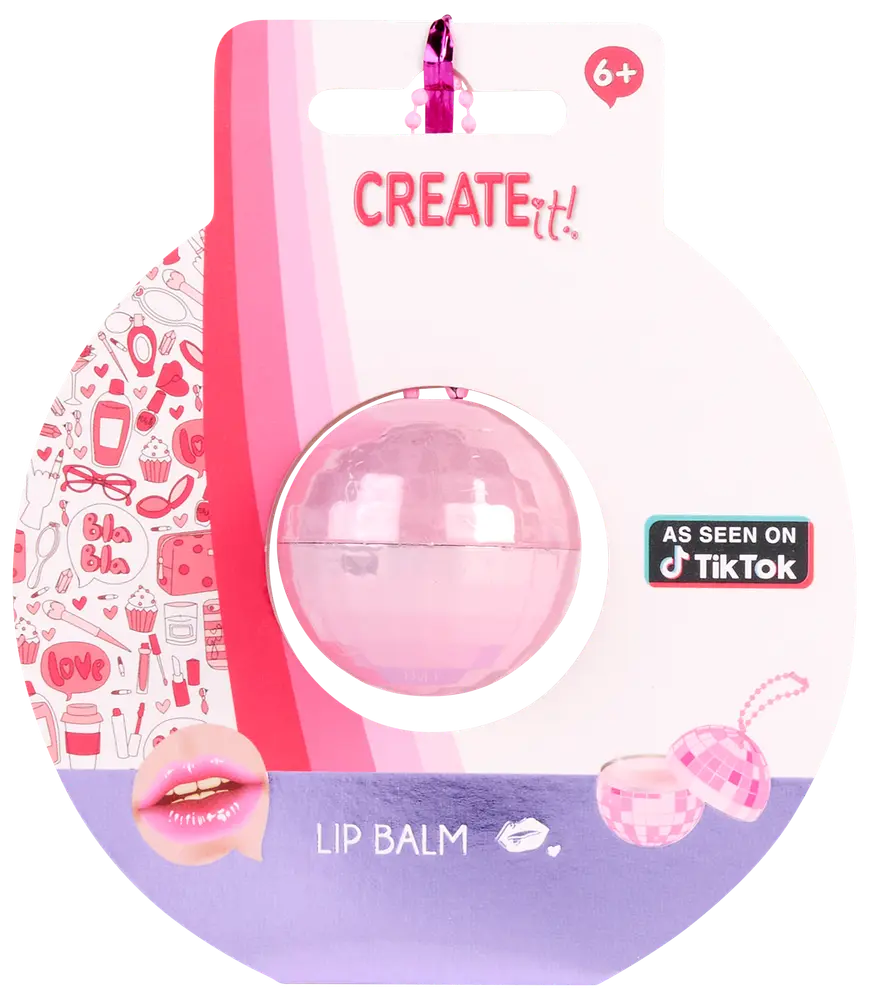 Kugleformet lyserød læbepomade i klar plastbeholder, pakket på farverigt kort med dekorationer. Velegnet til børn fra 6 år. Markedsført som set på TikTok.