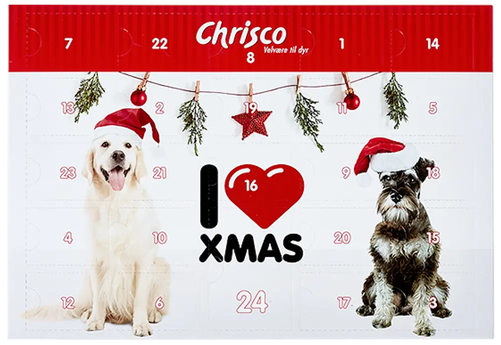 Adventskalender för hundar med två hundar i tomteluva, juldekorationer och numrerade luckor för dagliga godsaker. Från Chrisco, med festlig juldesign.