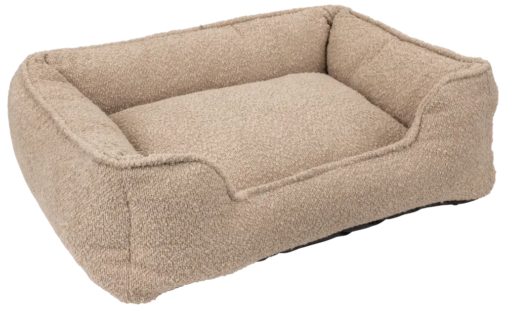 Rektangulær beige kæledyrsseng med hævede sider og blødt, tekstureret stof. Komfortabel støtte til kæledyr. Passer til små og mellemstore hunde eller katte. Aftagelig pude for nem rengøring.