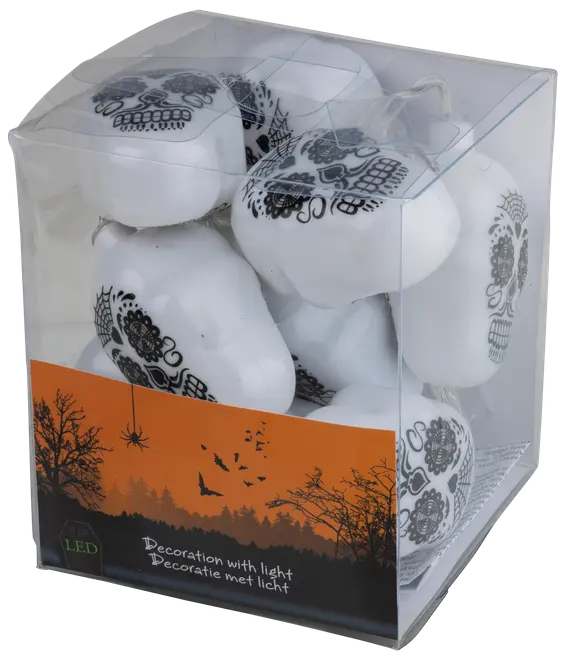 Förpackning med LED-belysta vita döskalledekorationer med svarta detaljerade mönster, perfekta för Halloween eller temafester. Döskallarna syns genom den klara förpackningen.