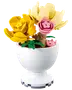 LEGO-lik blomsterarrangemang med gula, cremefärgade och rosa blommor i en vit vasformad kruka.