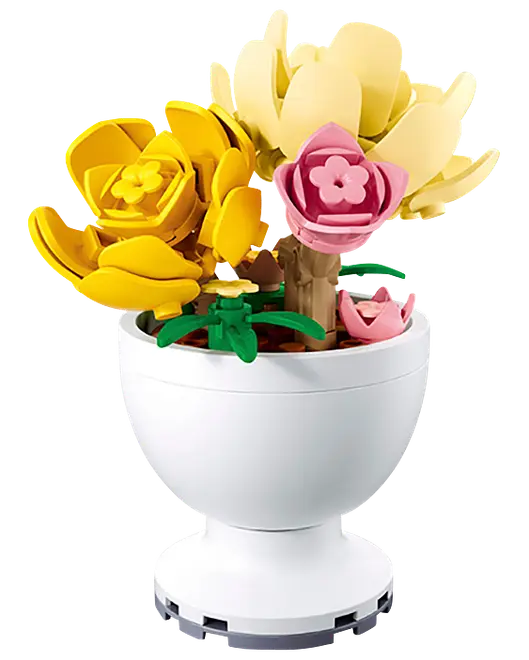 LEGO-lik blomsterarrangemang med gula, cremefärgade och rosa blommor i en vit vasformad kruka.
