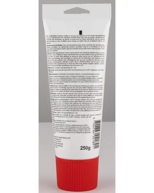 En hvid plasttube med et stort, riflet rødt skruelåg og ophængshul øverst. Bagsiden af tuben er dækket af detaljeret produktinformation, brugsanvisning og advarsler med sort tekst. Tuben indeholder 250 gram, hvilket er angivet nederst, og der er også stregkode samt producentoplysninger.