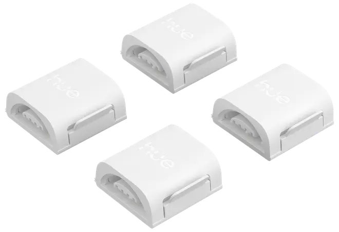 Sæt med fire hvide plastikforbindelser til LED-lysbånd, kompakte og rektangulære med snap-on design, ideelle til at forbinde eller forlænge Philips Hue lysbånd nemt og sikkert.