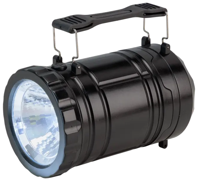 Sort bærbar LED-spotlight med cylindrisk krop, tekstureret greb, stor frontlinse og robust bærehåndtag. Velegnet til udendørs brug, camping eller nødbelysning.