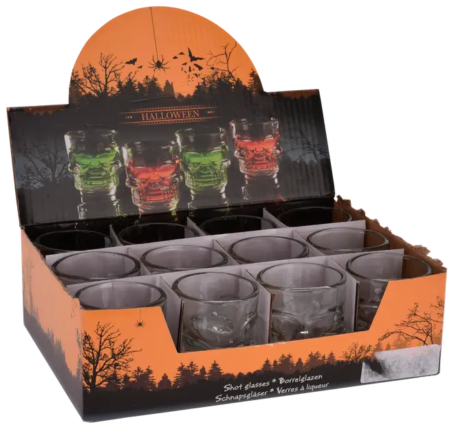 Tolv klara shotglas formade som dödskallar, presenterade i en Halloween-tema orange och svart låda med skog och spindelgrafik.