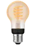 Philips Hue smartpære med klart glas, spiralfilament, varm ravfarvet glød og skruelampefatning.