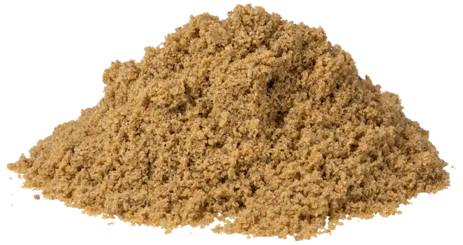 En bunke fintmalet, lysebrunt pulver, sandsynligvis et krydderi som stødt spidskommen, med blød, smuldrende konsistens til krydring og madlavning.