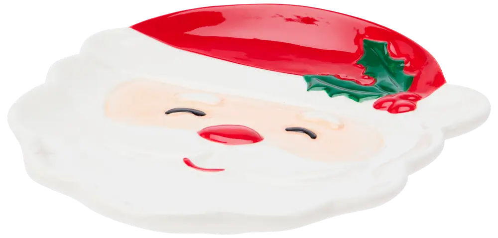 Keramiktallrik formad som jultomtens ansikte med röd luva, järnek, vitt skägg och leende uttryck. Festlig design, perfekt för julgodis eller dekoration.
