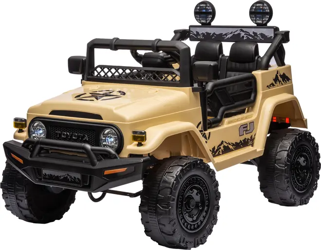 Beige elbil til børn, designet som en Toyota FJ Cruiser med terrændæk, åbne sider, to sæder, frontgitter, forlygter og bjerggrafik. Robust offroad-look.
