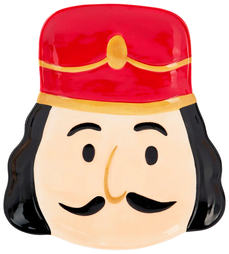 Keramiktallrik formad som en nötknäckares ansikte med röd hatt, svart hår, mustasch och enkla målade ansiktsdrag. Perfekt för festdukning.