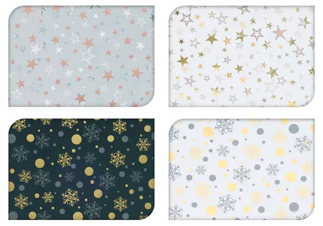Fyra rektangulära bordsunderlägg med festliga stjärn- och snöflingemönster i guld, silver och pastell på vita, grå och mörka bakgrunder. Lätt att torka av.