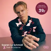 Mørk struktureret blazer dekoreret med flere lyserøde og bordeaux sløjfer, der støtter brystkræftsagen. Sløjferne er fastgjort foran og på ærmerne som pynt.