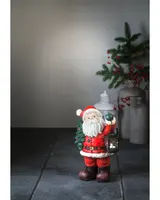 Jultomte med gran och lanterna
