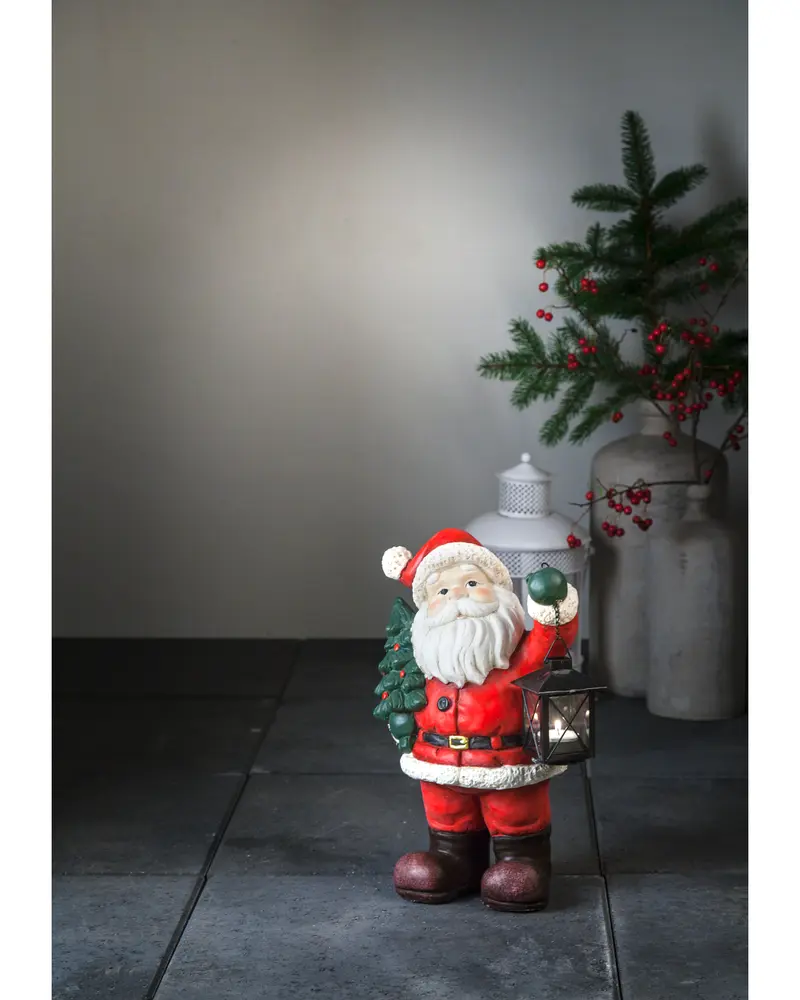 Jultomte med gran och lanterna