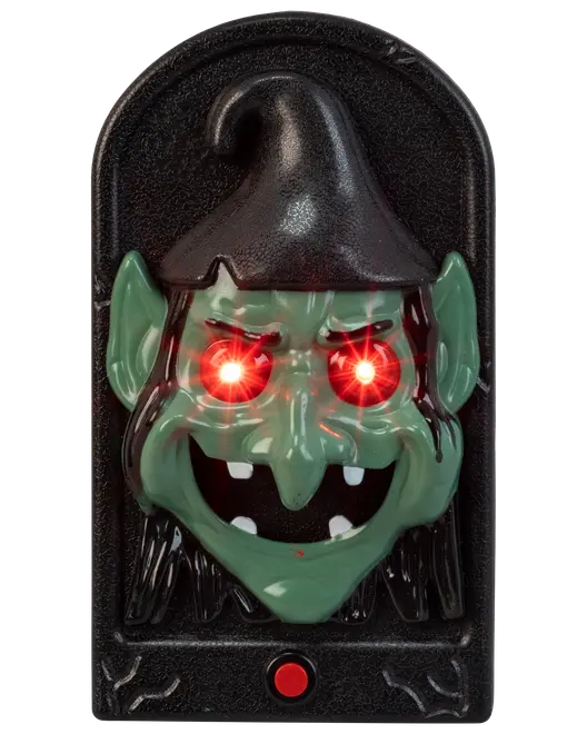 Halloween-dekoration med grönt häxansikte, spetsiga öron, svart hatt, lysande röda LED-ögon och röd knapp på svart rektangulär bakgrund. Tillverkad av plast.