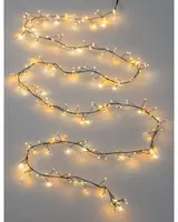A long, flexible string of warm white LED lights arranged on a thin, dark wire. The lights are spaced irregularly along the wire, with small branches extending out to create a delicate, twinkling effect. The overall look is airy and elegant, suitable for decorative use in various settings.