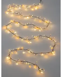 A long, flexible string of warm white LED lights arranged on a thin, dark wire. The lights are spaced irregularly along the wire, with small branches extending out to create a delicate, twinkling effect. The overall look is airy and elegant, suitable for decorative use in various settings.