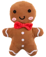 Mjuk pepparkaksgubbe med broderade ögon, leende, rosa kinder, vita knappar och röd fluga. Mjuk brun tyg med vita glasyrdetaljer på armar och ben.