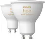 To Philips Hue White Ambiance LED-spotpærer med GU10-fatning, hvid finish og bred reflektordesign.