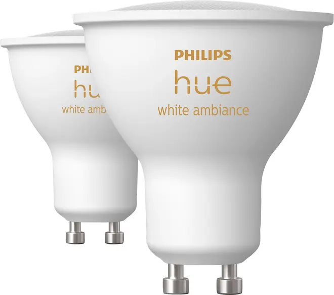 To Philips Hue White Ambiance LED-spotpærer med GU10-fatning, hvid finish og bred reflektordesign.