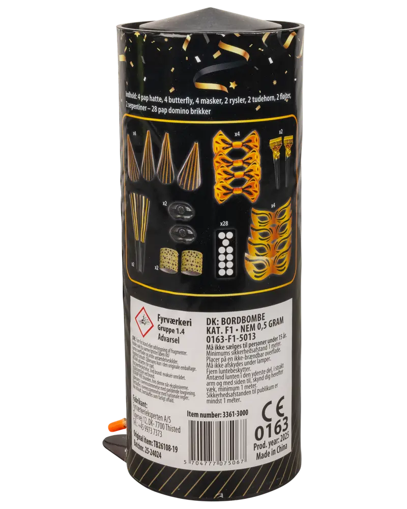Bordbombe med pap-hatte, butterflys, masker, fløjter, terninger, dominobrikker og konfetti. Sort og guld emballage med indholdet illustreret på etiketten.