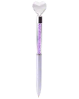 A pen with a decorative clear heart-shaped topper, a transparent barrel filled with small purple crystals, and a sleek light purple lower body. The pen has a metallic accent separating the crystal-filled section from the writing tip.
