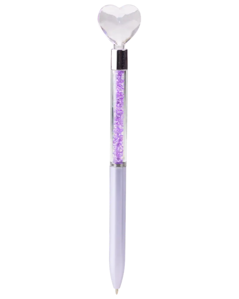 A pen with a decorative clear heart-shaped topper, a transparent barrel filled with small purple crystals, and a sleek light purple lower body. The pen has a metallic accent separating the crystal-filled section from the writing tip.